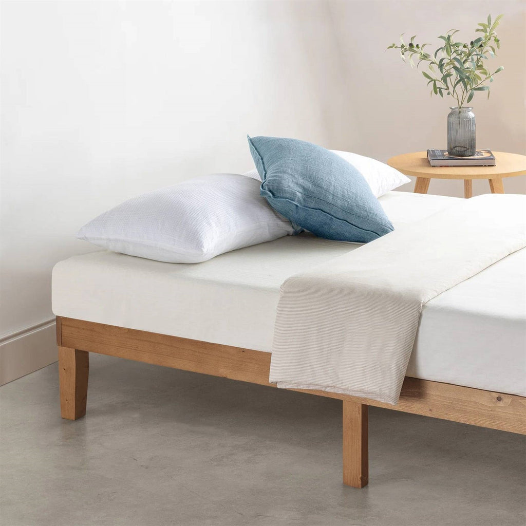 Natural wood platform bed frame with visible side rails and support legs