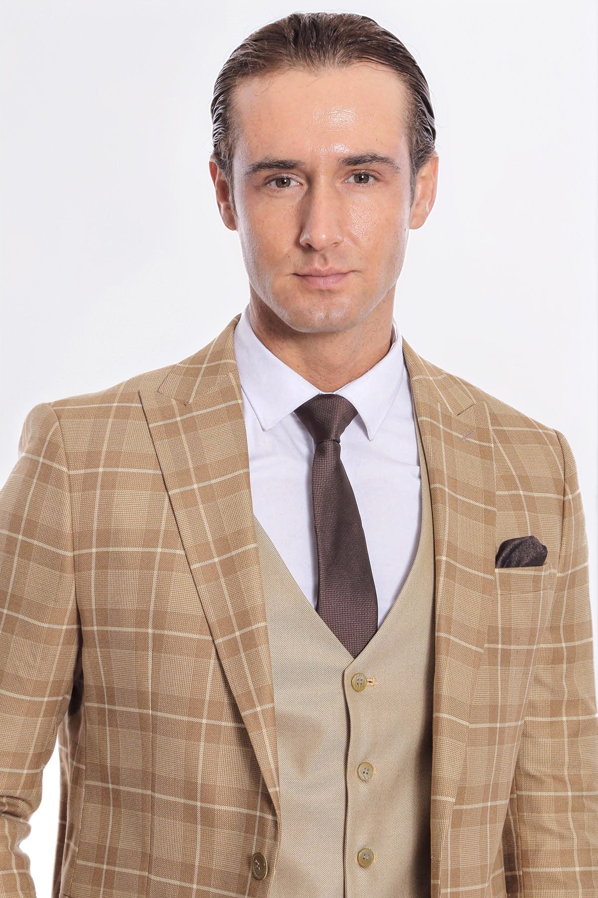 Men's checked tan blazer and beige waistcoat with dark tie, chest close-up