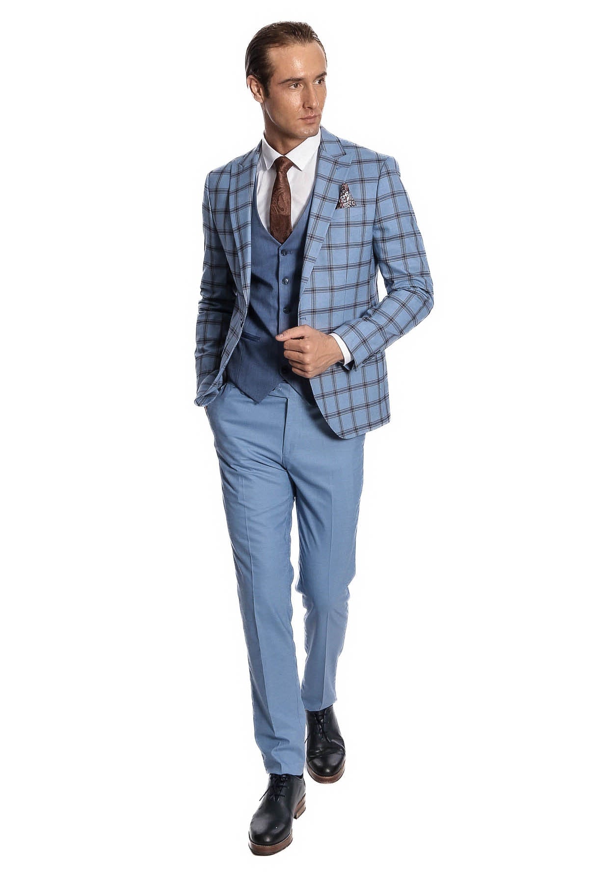 Men's slim fit plaid suit with light blue trousers, blue vest, brown tie, and pocket square