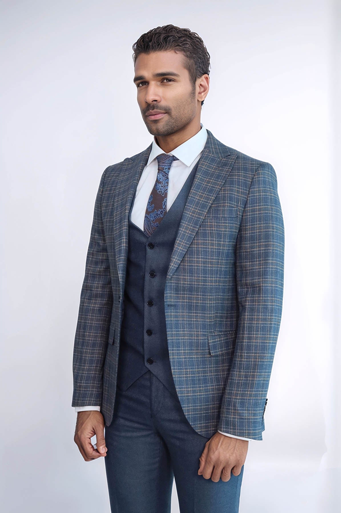 Men's slim fit checked suit jacket, dark blue vest and patterned tie