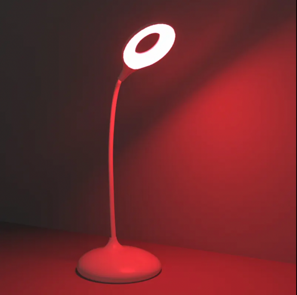 Red-lit table lamp with curved neck and circular light head