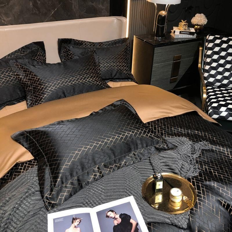 Black cotton satin bedding set with gold geometric grid pattern, pillows, and tan top sheet