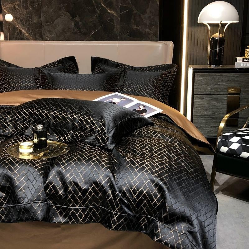 Black cotton satin bedding set with gold geometric grid pattern, pillows, and tan accent sheet