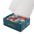 Herbal tea sampler gift box open, showing assorted tea packets inside