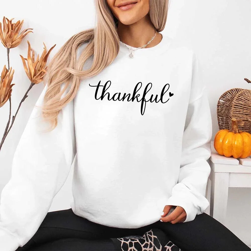 White crewneck sweatshirt with “thankful” script print and long sleeves