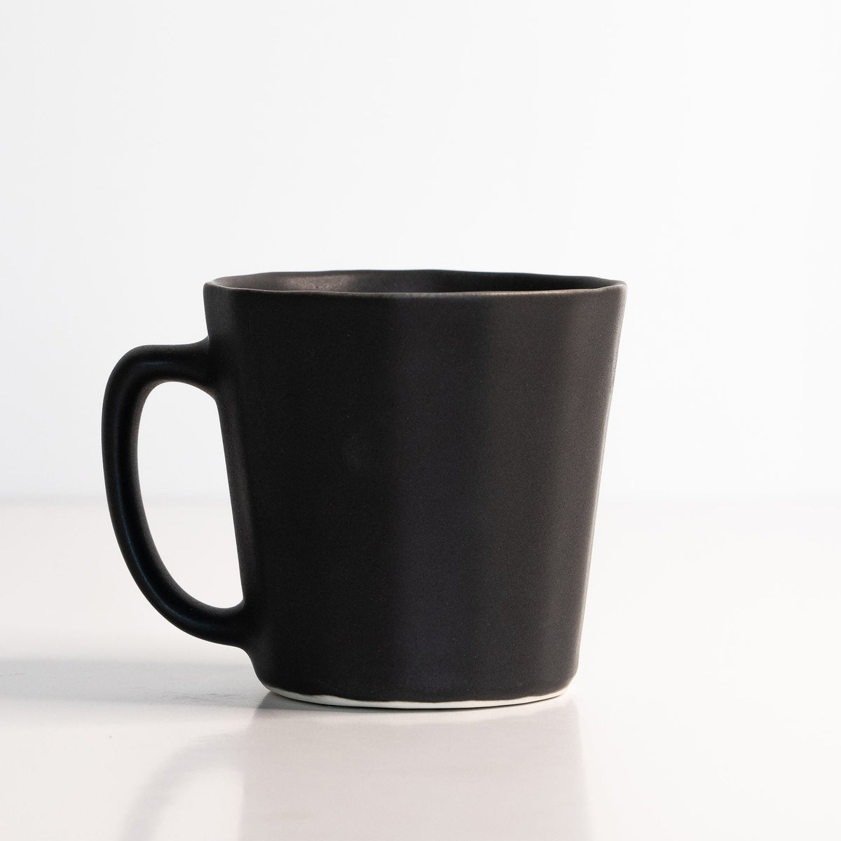 Handmade porcelain coffee mug, dark charcoal black with curved handle