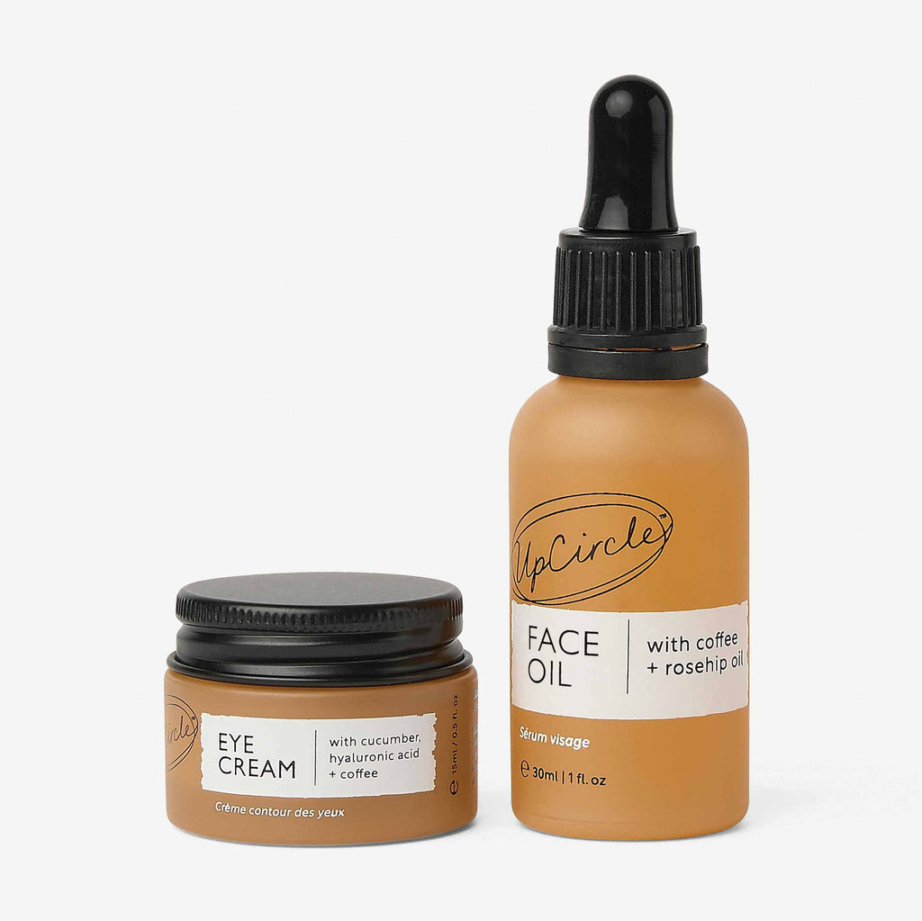 Face oil bottle and eye cream jar duo skincare set, both with dark lids