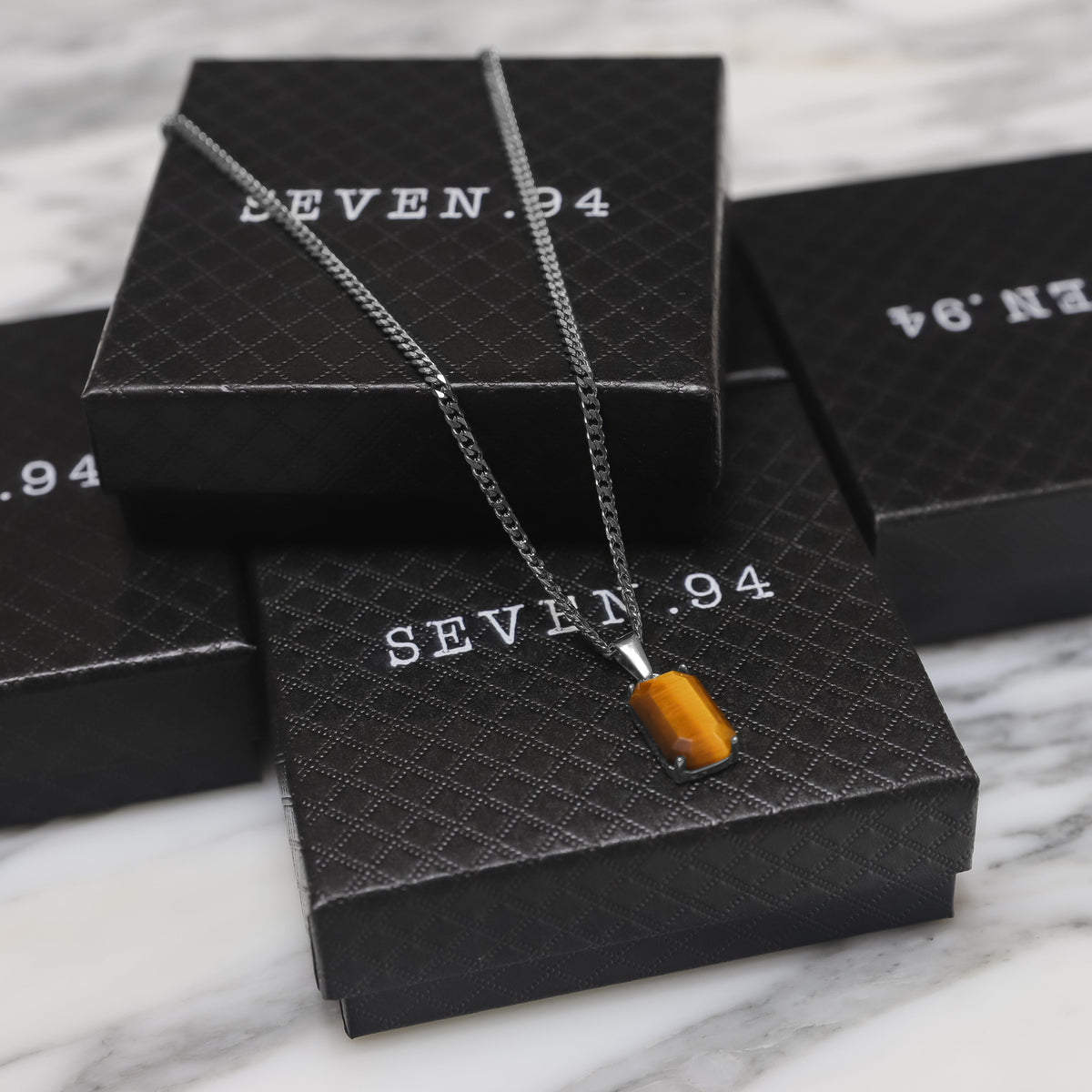 Tiger eye stone pendant on silver-tone chain, rectangular stone detail