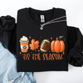 Black crewneck sweatshirt with “Tis the Season” football, pumpkins, and coffee graphic.