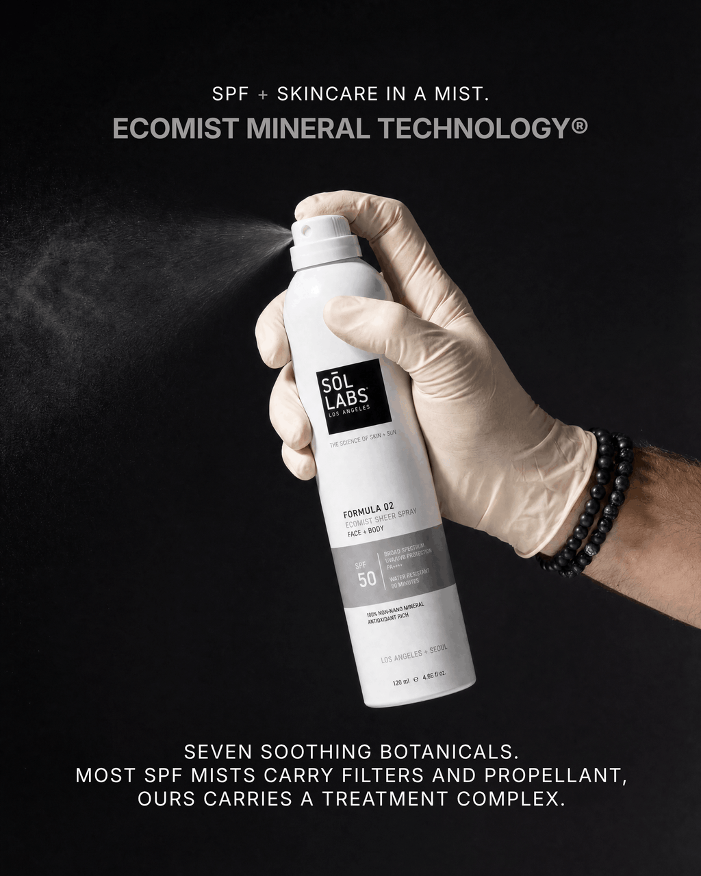 Ecomist SPF 50 face and body mineral spray bottle held by a gloved hand