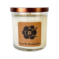 Soy candle in clear glass jar with copper lid, cream wax and floral label