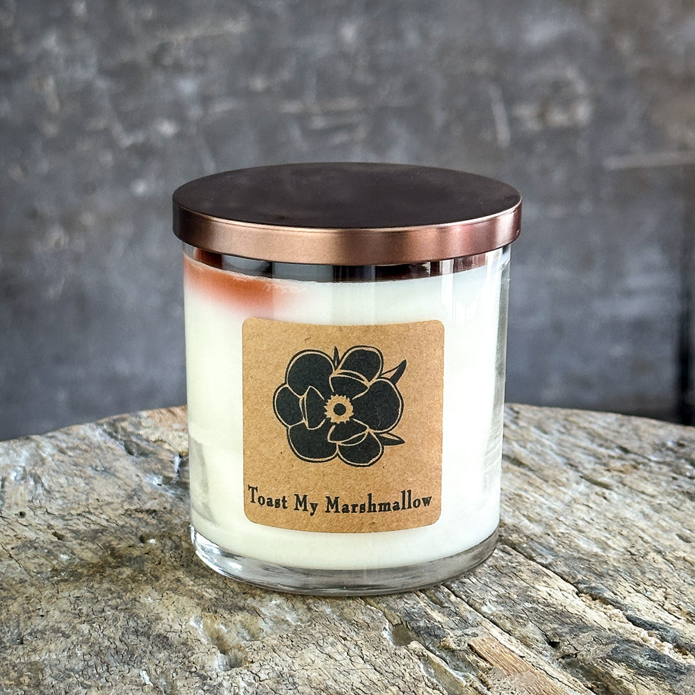 Soy candle in glass jar with copper lid, cream wax and floral logo label