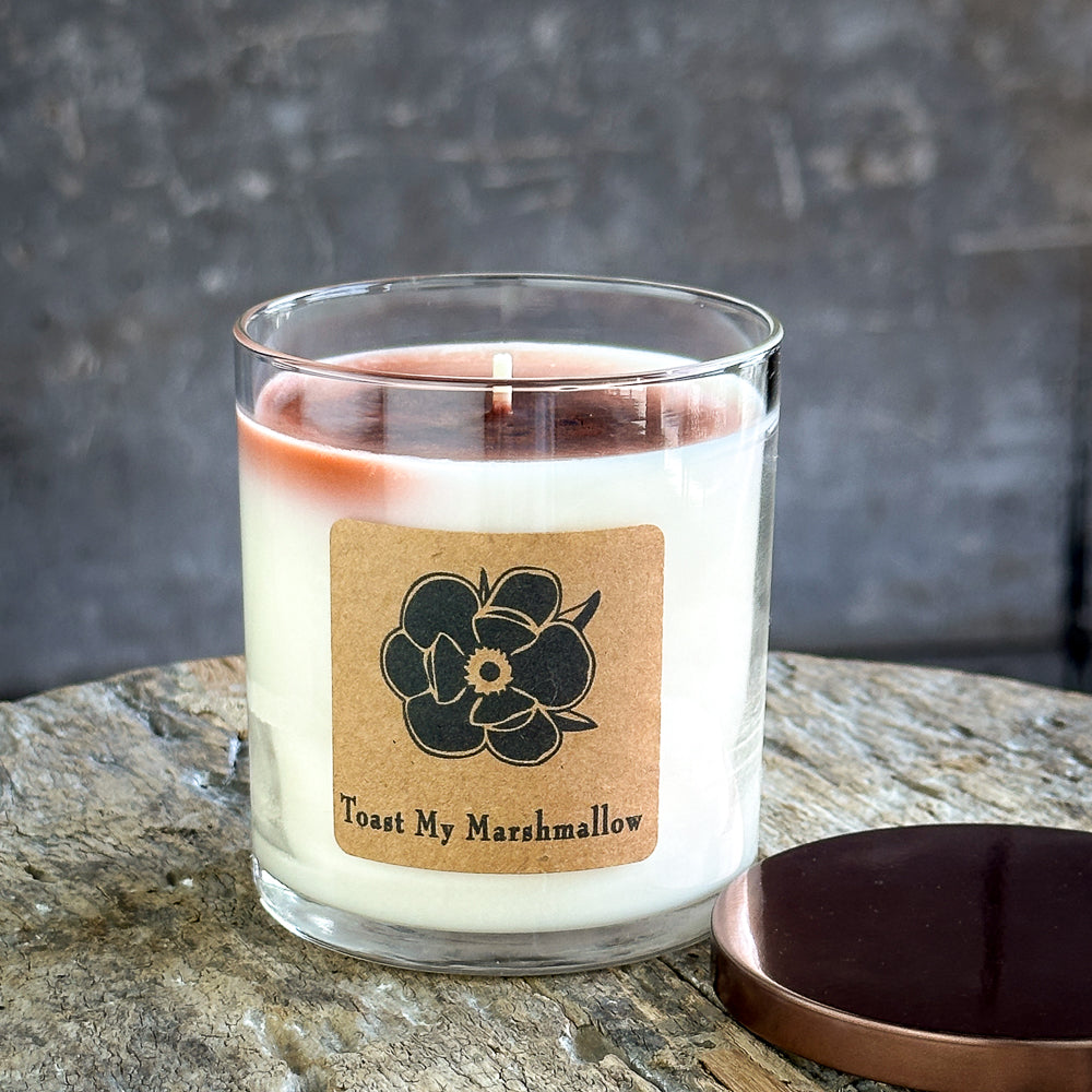 Soy candle in glass jar with open top, cream wax and floral label