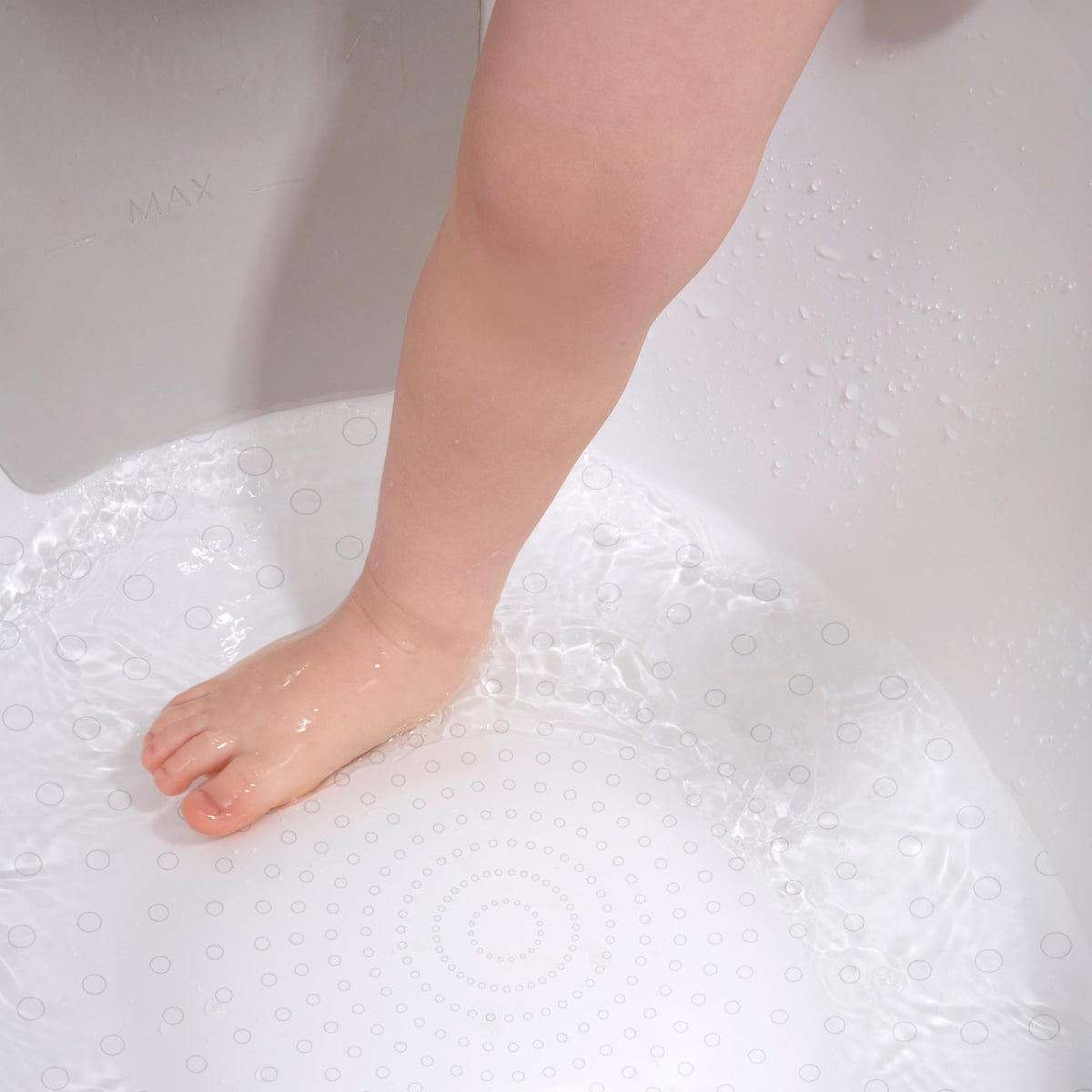 Toddler bath tub base with raised anti-slip texture, showing water bubbles
