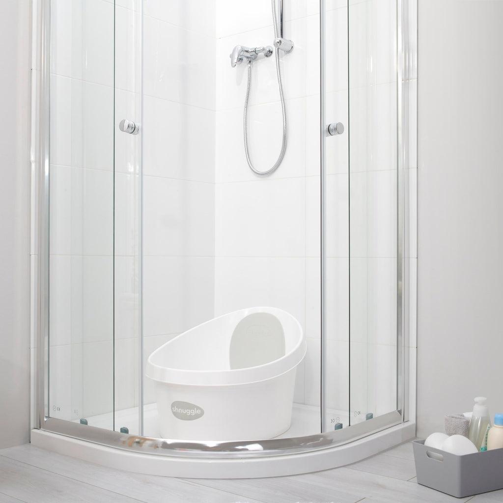 Toddler bath tub with white backrest, placed inside a shower enclosure