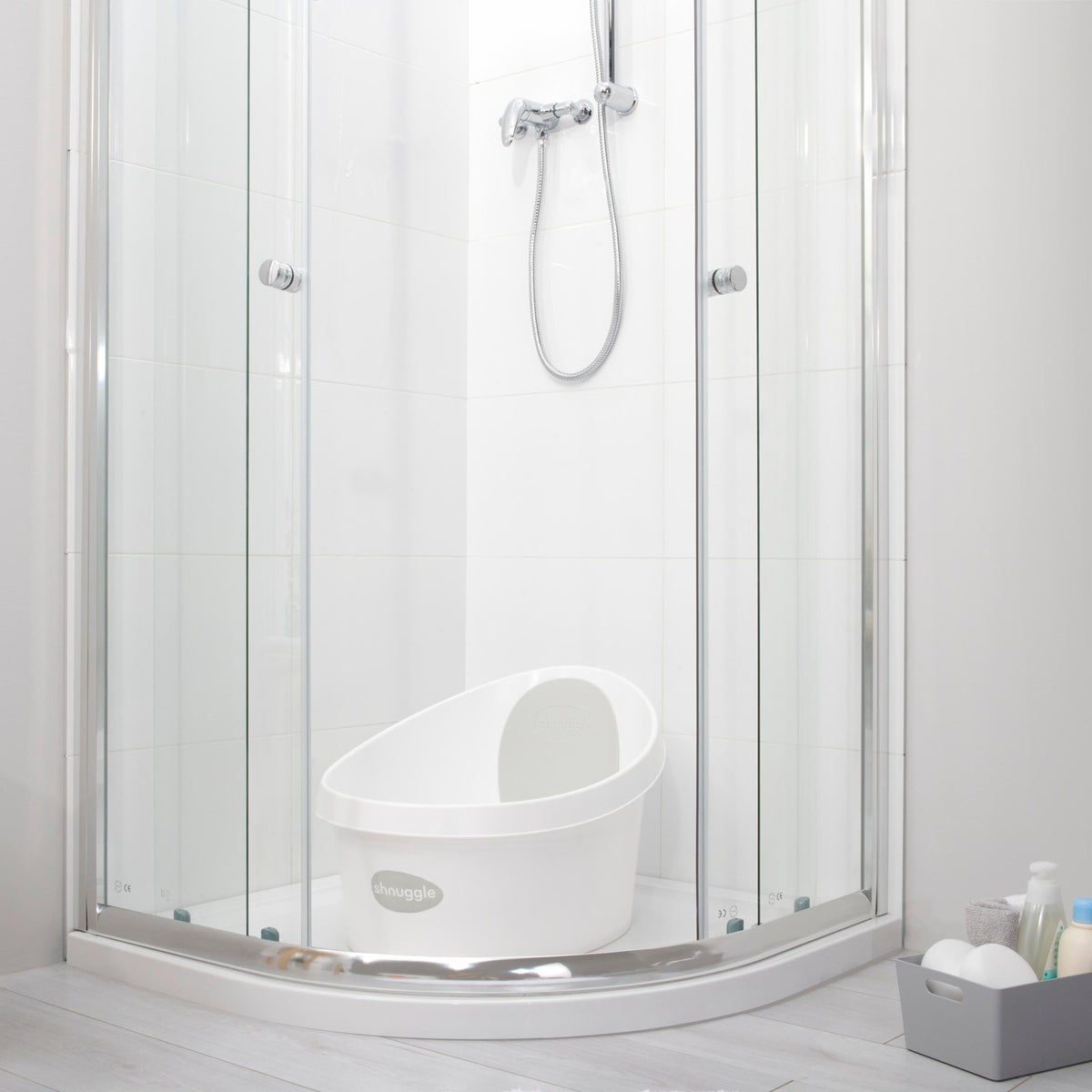 Toddler bath tub with white backrest, placed inside a shower enclosure