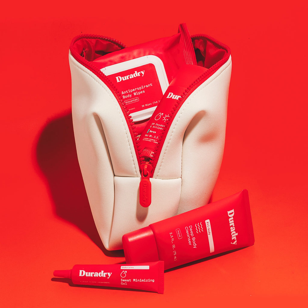 Cream travel bag open with red Duradry packets and tubes inside pouch.
