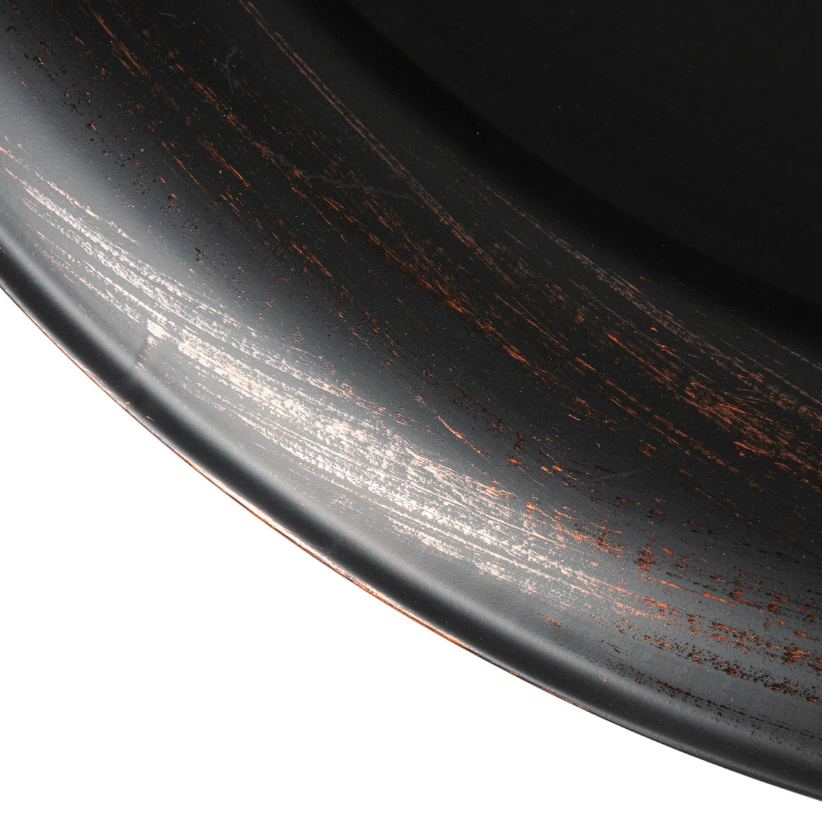 Close-up of black fire pit rim with speckled rust finish