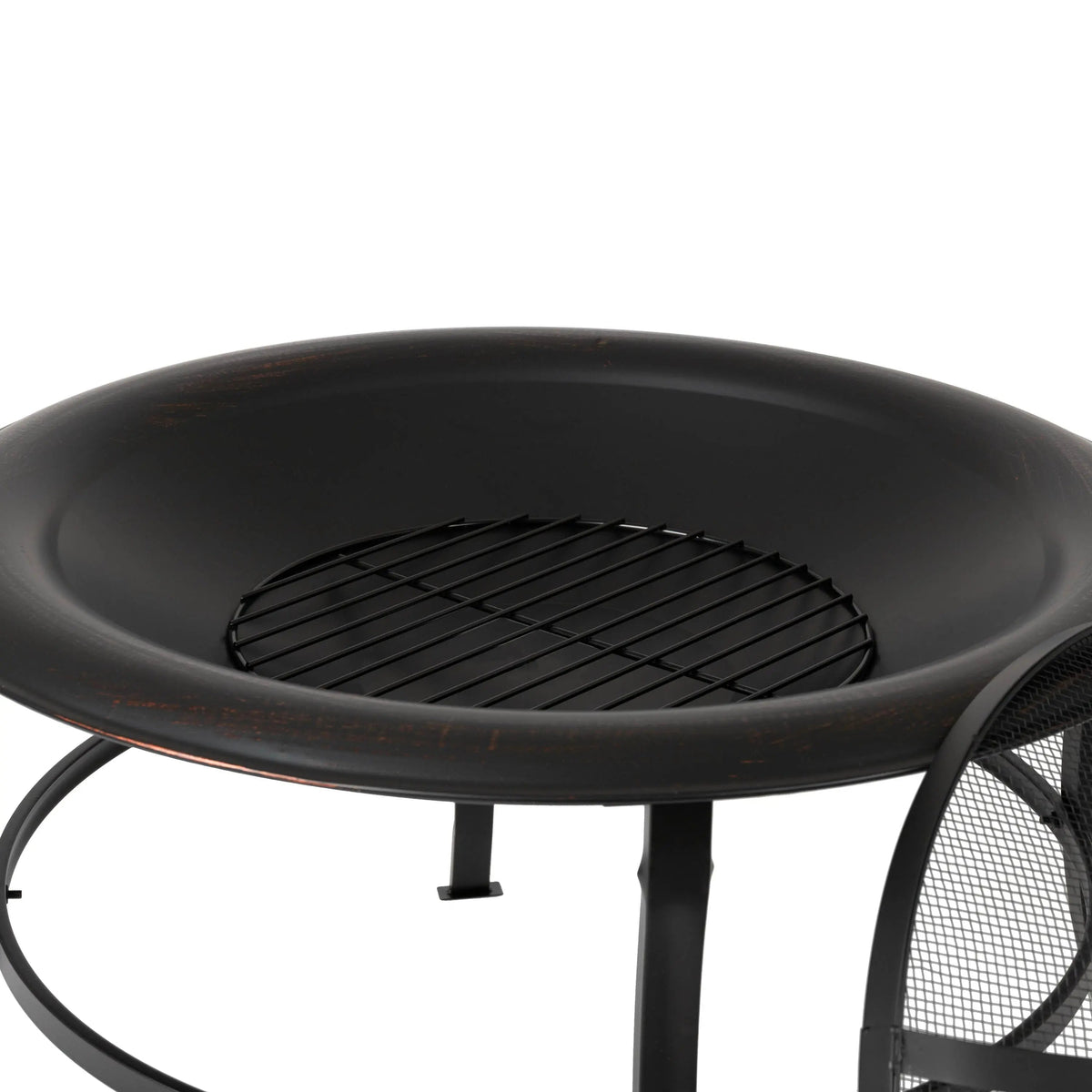 Close-up of round fire pit interior with grate over dark bowl