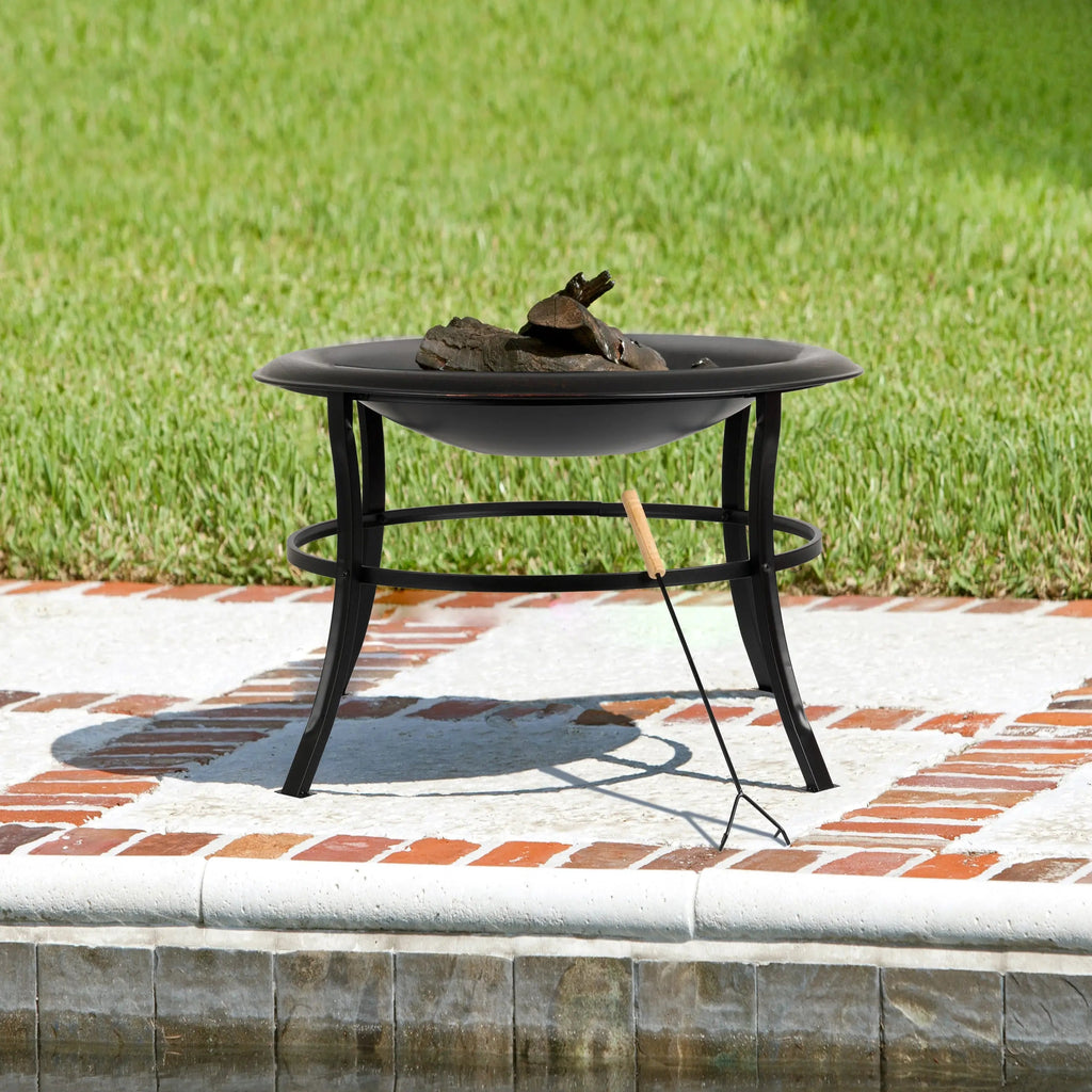 Outdoor round fire pit with spark screen and logs on the metal fire bowl