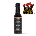 Hot sauce bottle with black label and orange band, charred habanero & manzano chili.