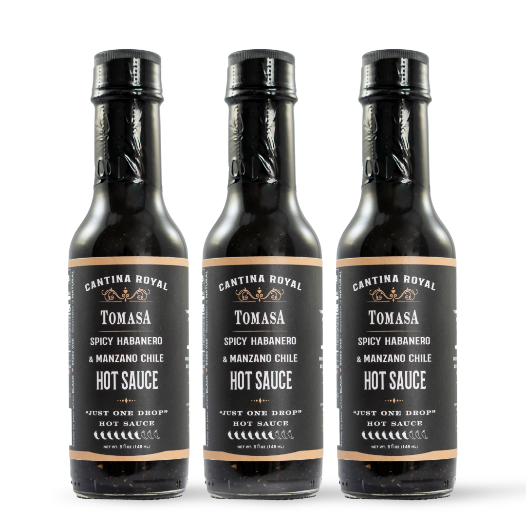 Three hot sauce bottles with black caps and labels, spicy habanero variety.