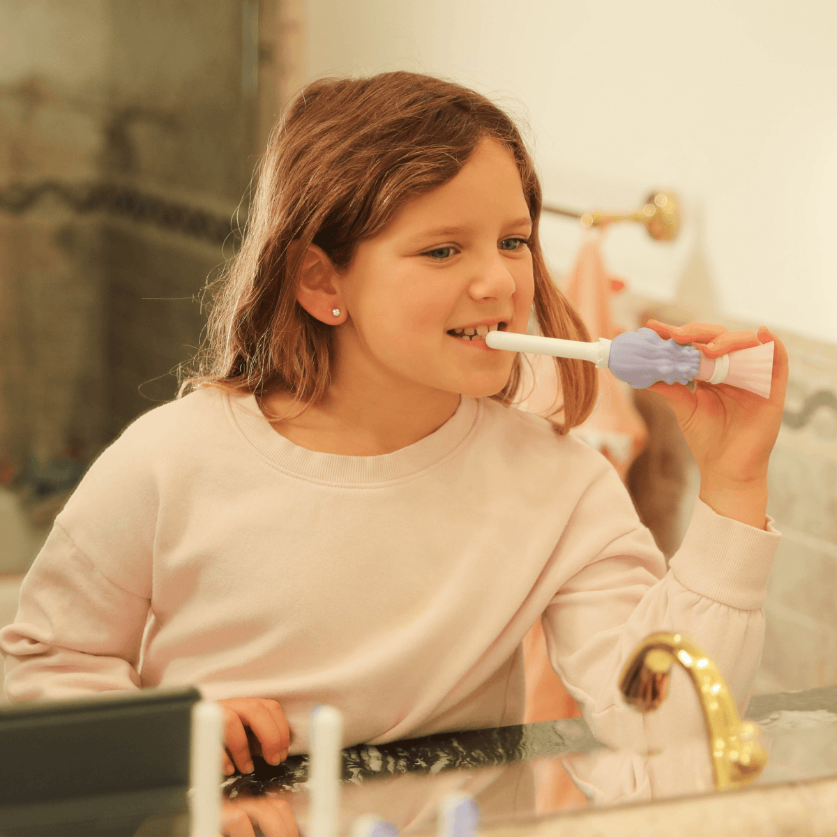 Kids toothbrush in use: child brushing with white handle and pink bristles
