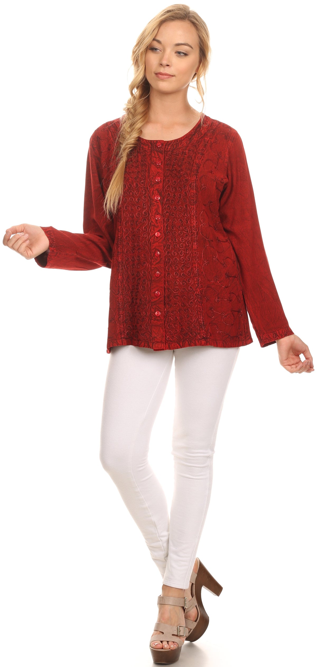 Red long-sleeve blouse with deep scoop neck, button front, patterned design on white pants