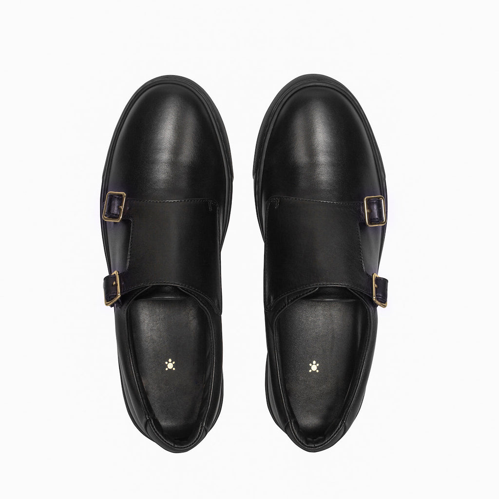 Pair of black slip-on loafers with gold-tone buckles