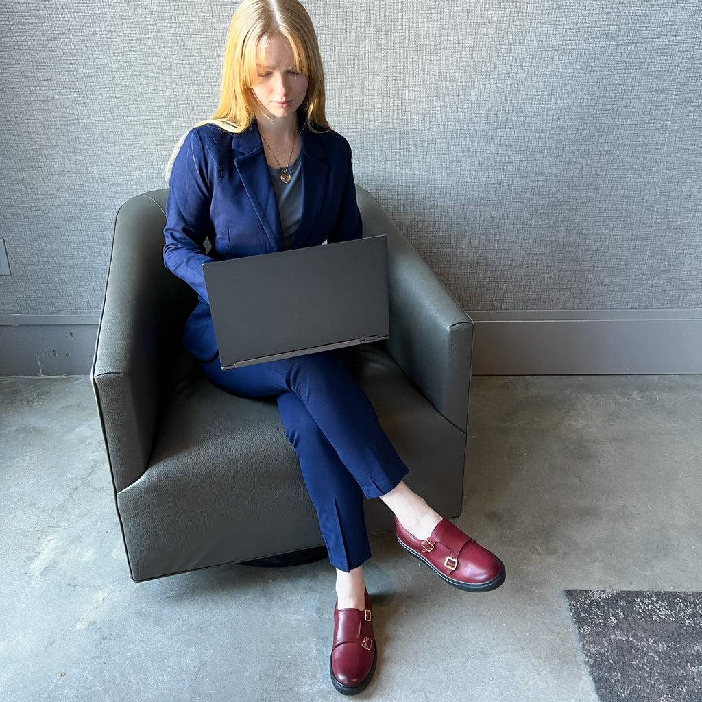 Women’s dark red slip-on shoes with buckle straps worn with blue outfit