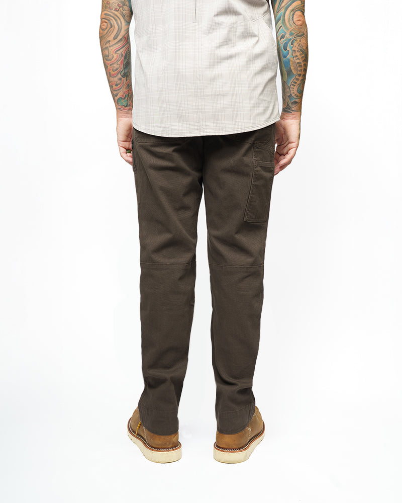 Dark brown taper-fit pants close view of legs with seam stitching and belt loops.