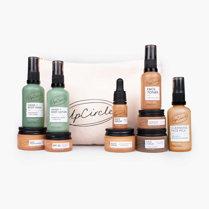 Travel-size skincare bundle featuring facial toner, serum, cleanser, and lotion bottles