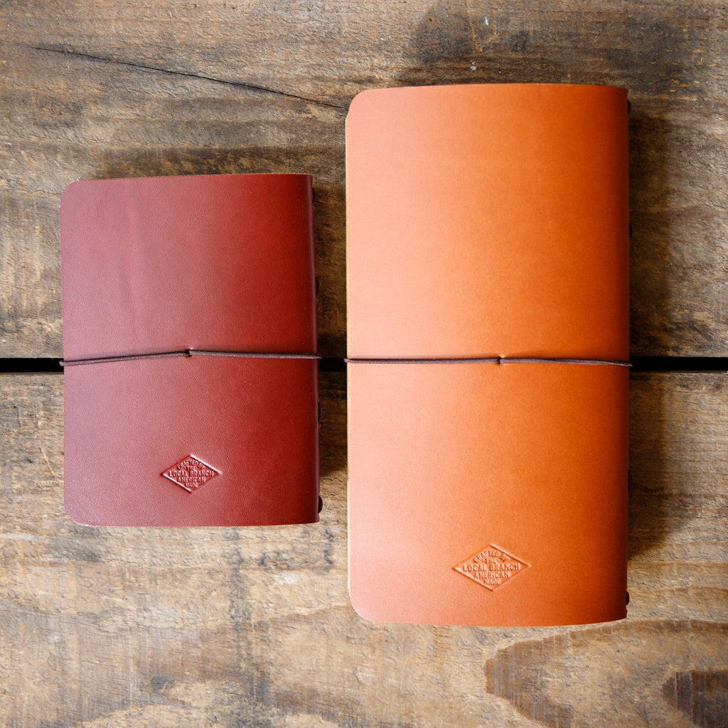 Leather traveler notebooks set with strap closure, caramel and dark red colors