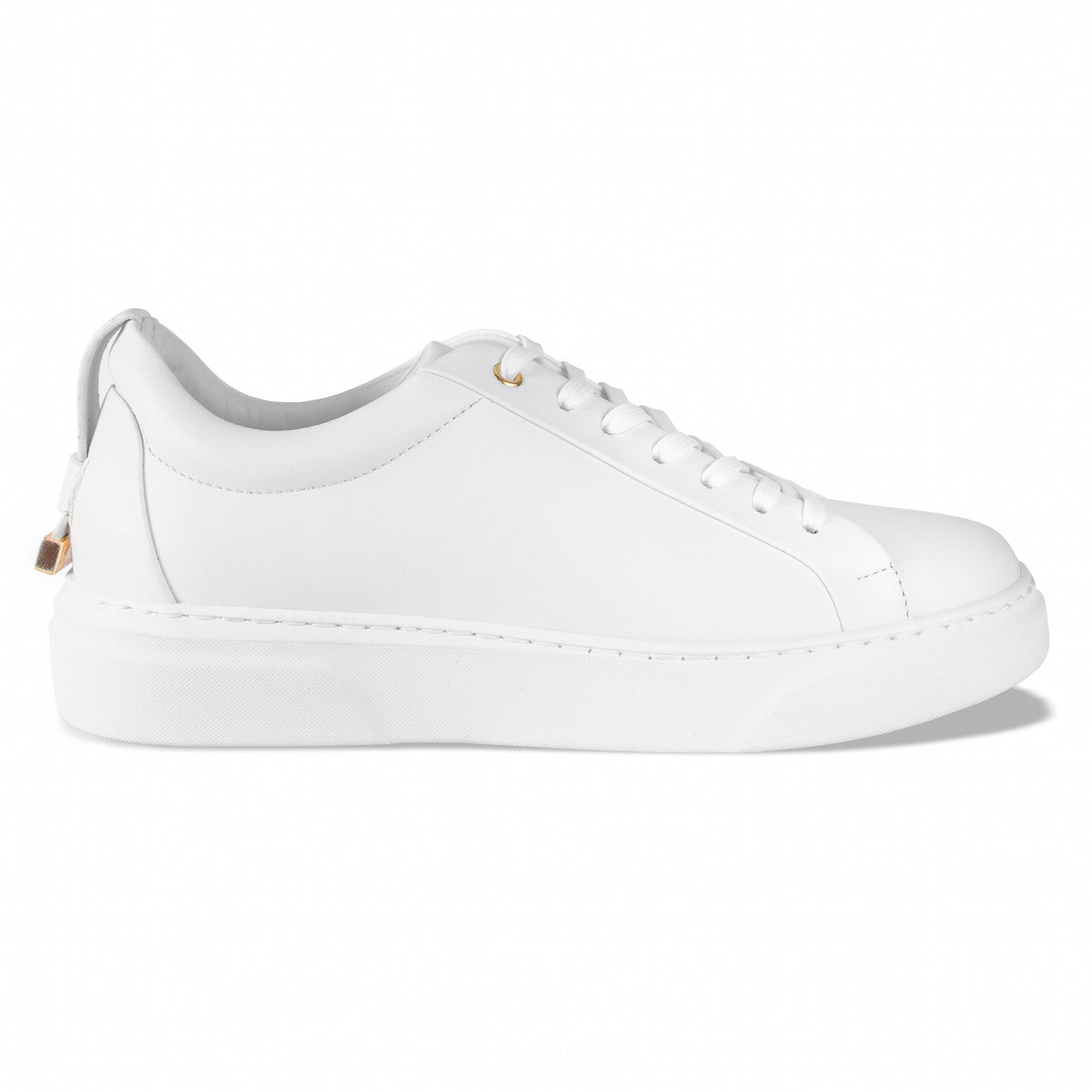 White low-top sneakers with white laces, gold lace tips, and thick platform sole