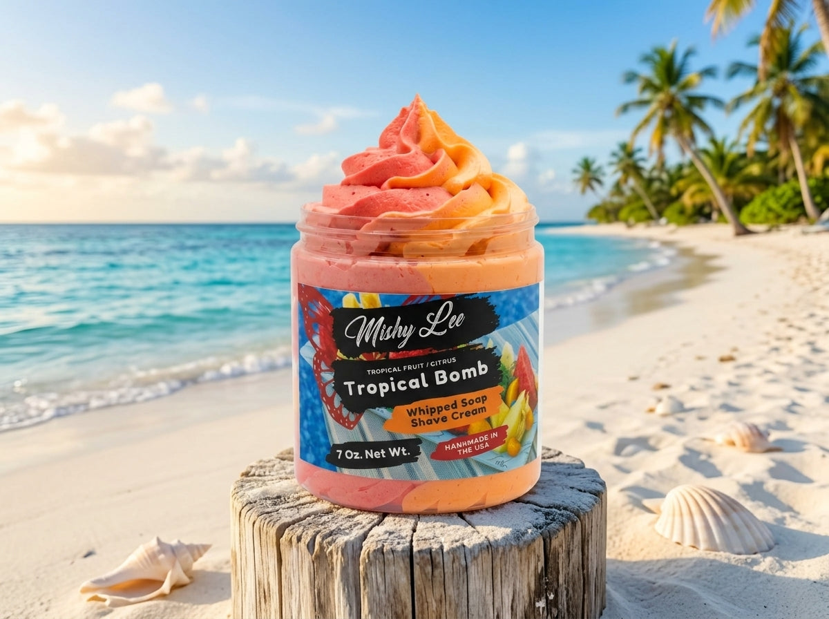 Whipped soap and shave cream jar with Tropical Bomb label on a beach log