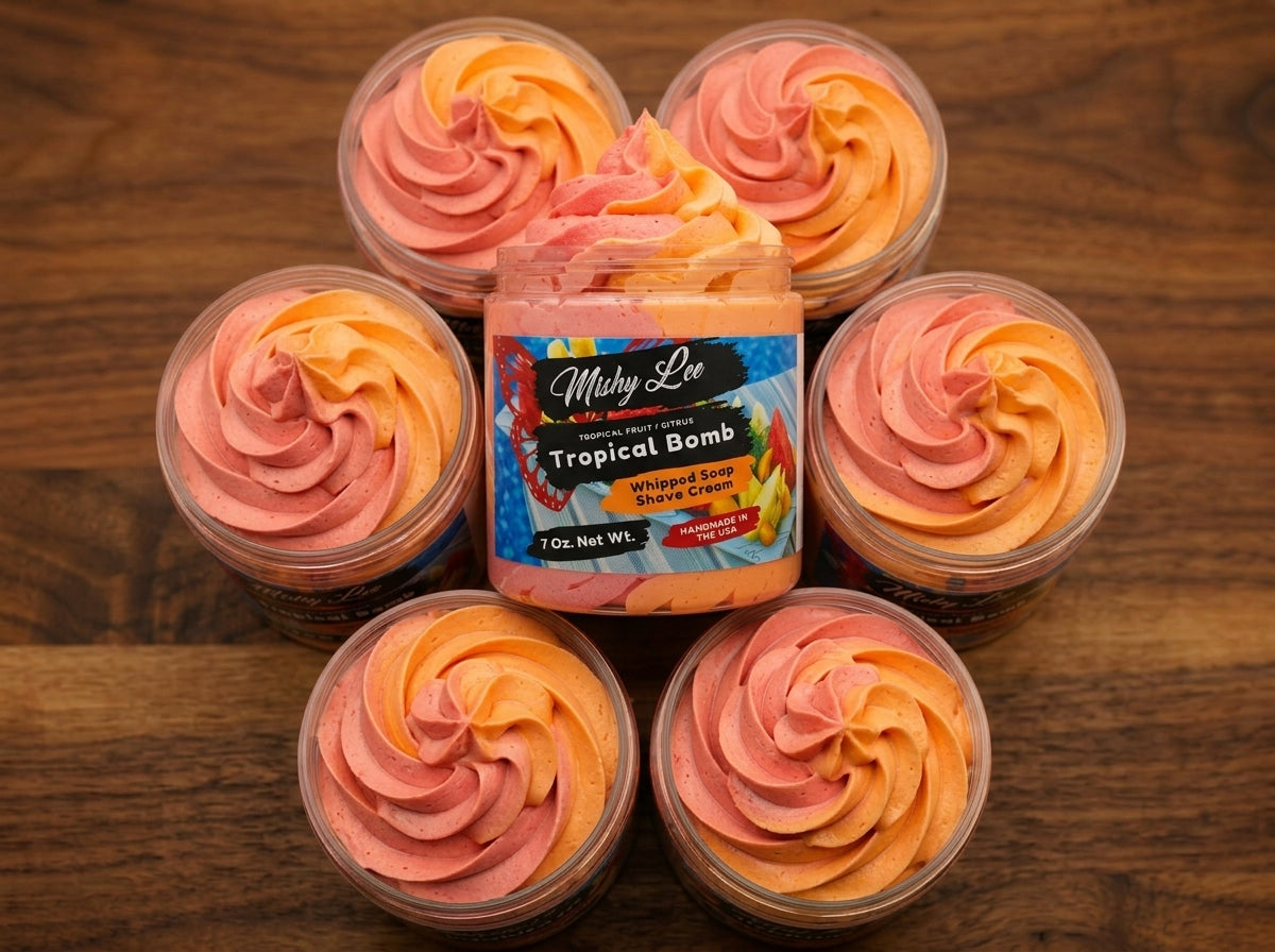 Multiple small jars of orange and pink whipped soap swirls around the main jar