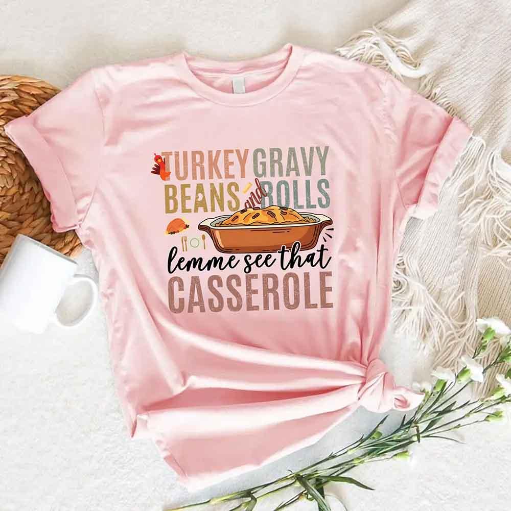 Pink short-sleeve graphic T-shirt with Turkey gravy beans and rolls casserole front print