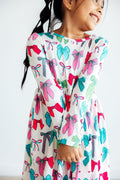 Girls long-sleeve twirl dress with colorful bow print, gathered skirt and ruffle hem