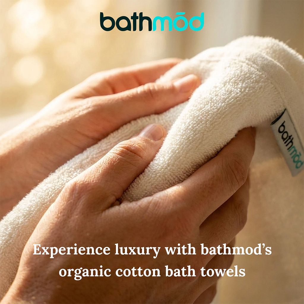 Hands smoothing a folded white bath towel edge, plush woven texture