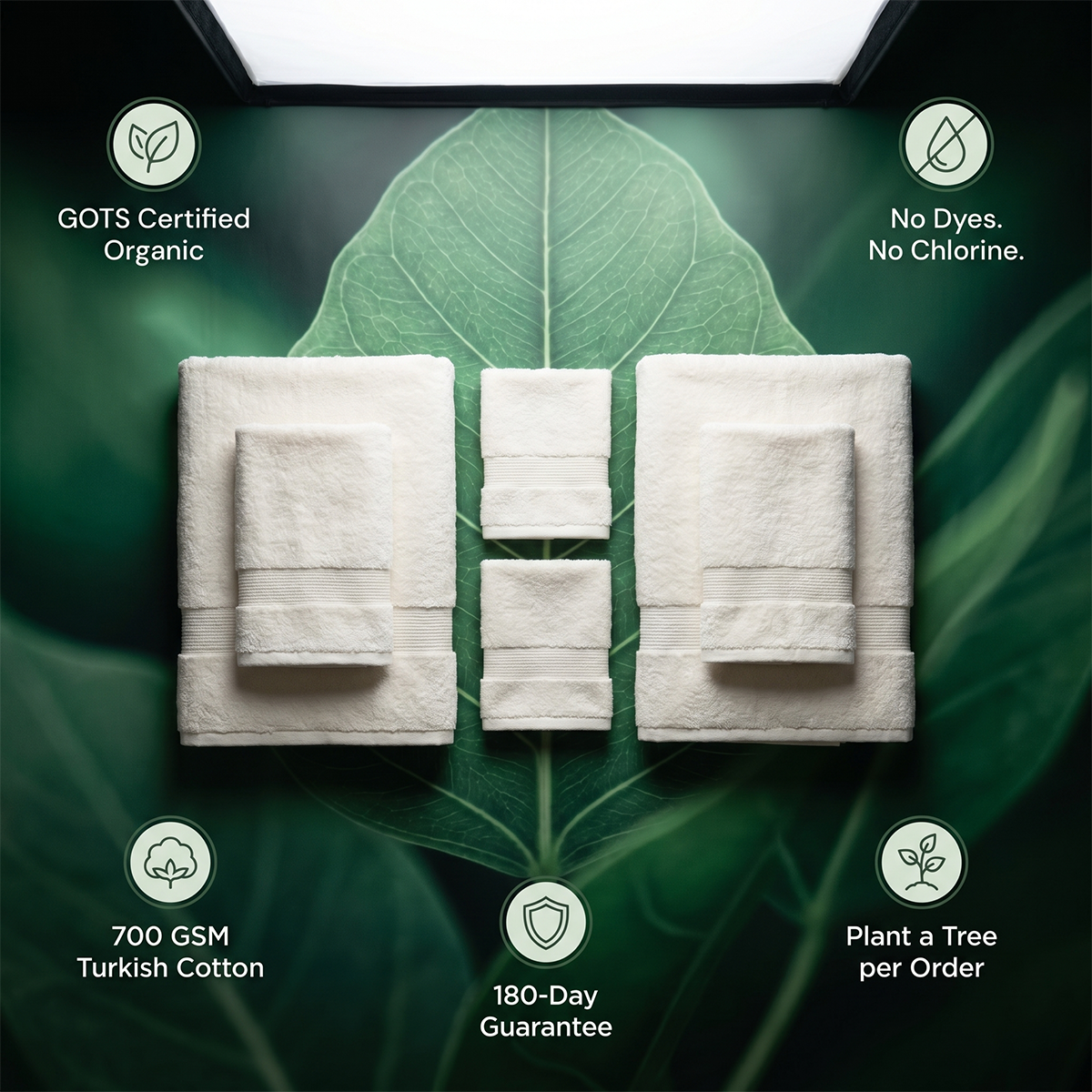 White towel set displayed flat: two bath towels plus smaller wash towels, plush