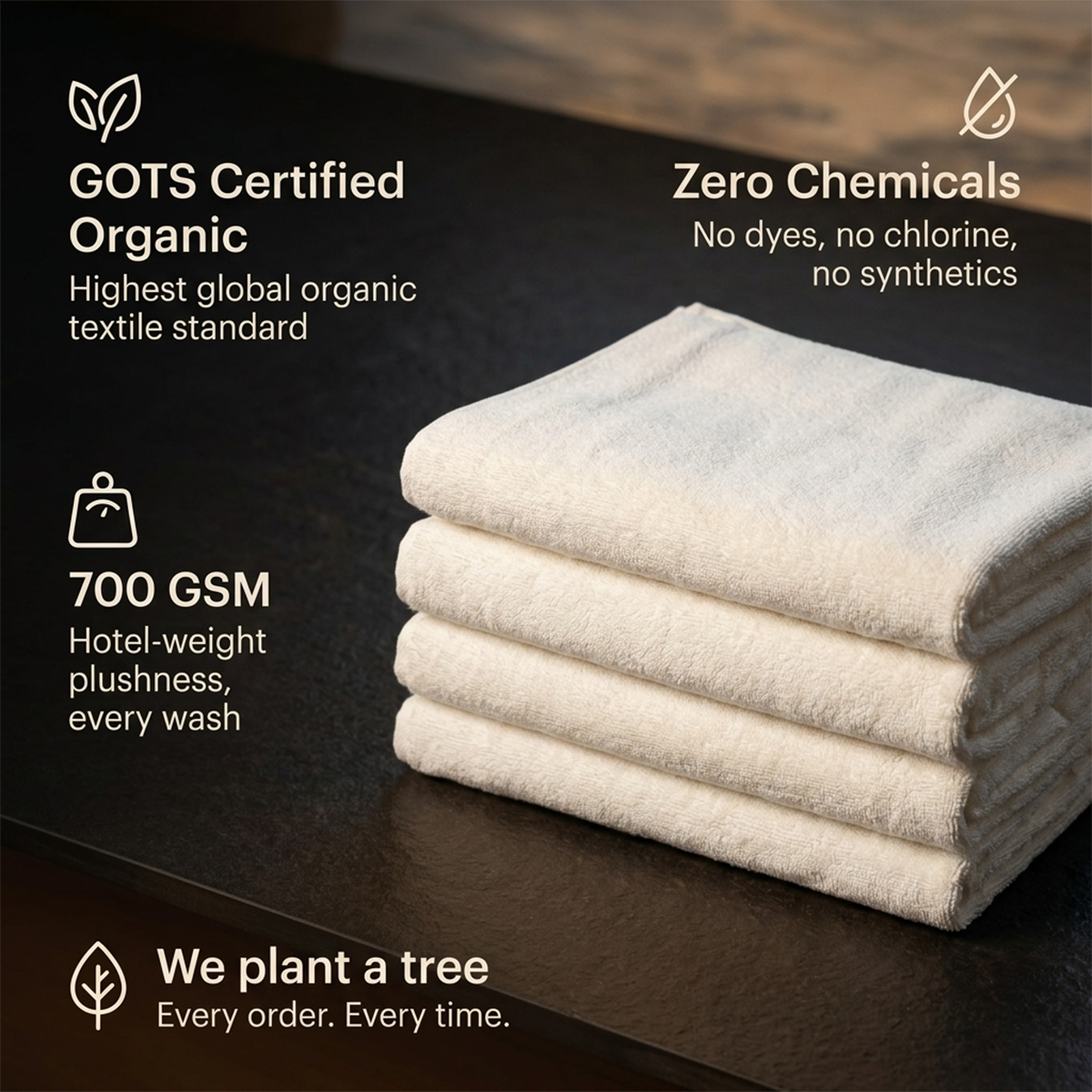 Folded white bath towels stacked neatly, hotel-weight plush look