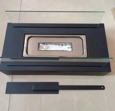 Black mini alcohol fireplace with clear glass window and burner tube
