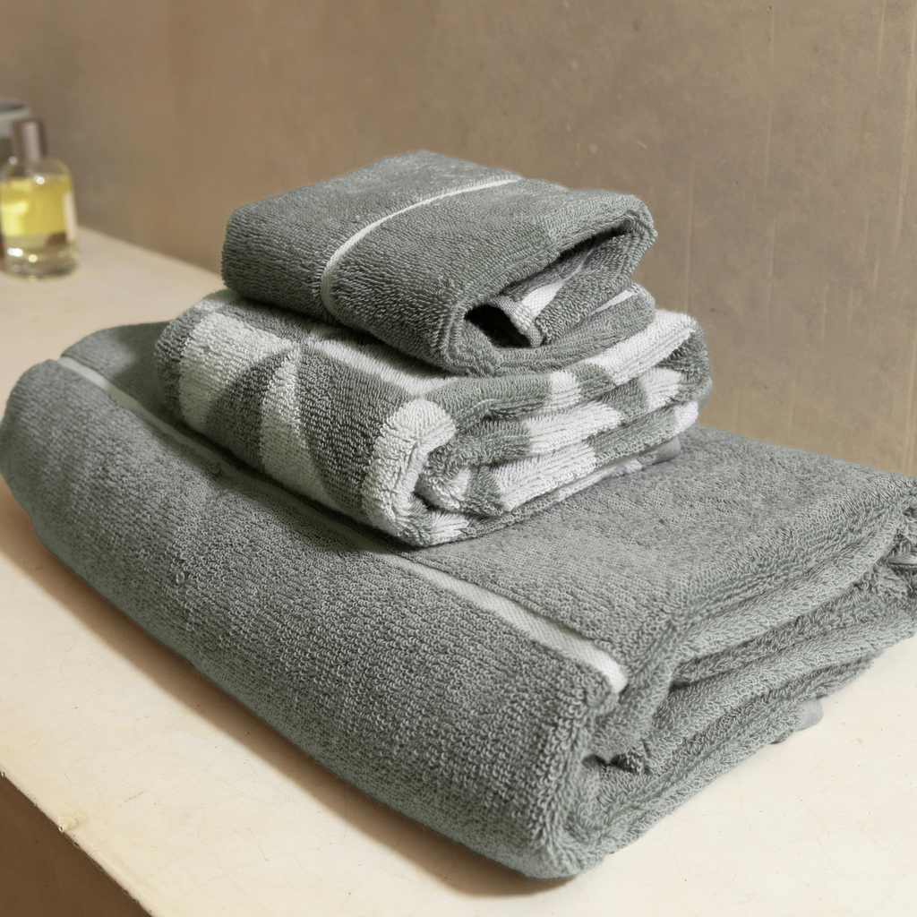 Sage green cotton towel roll stack with white stripes and soft terry texture