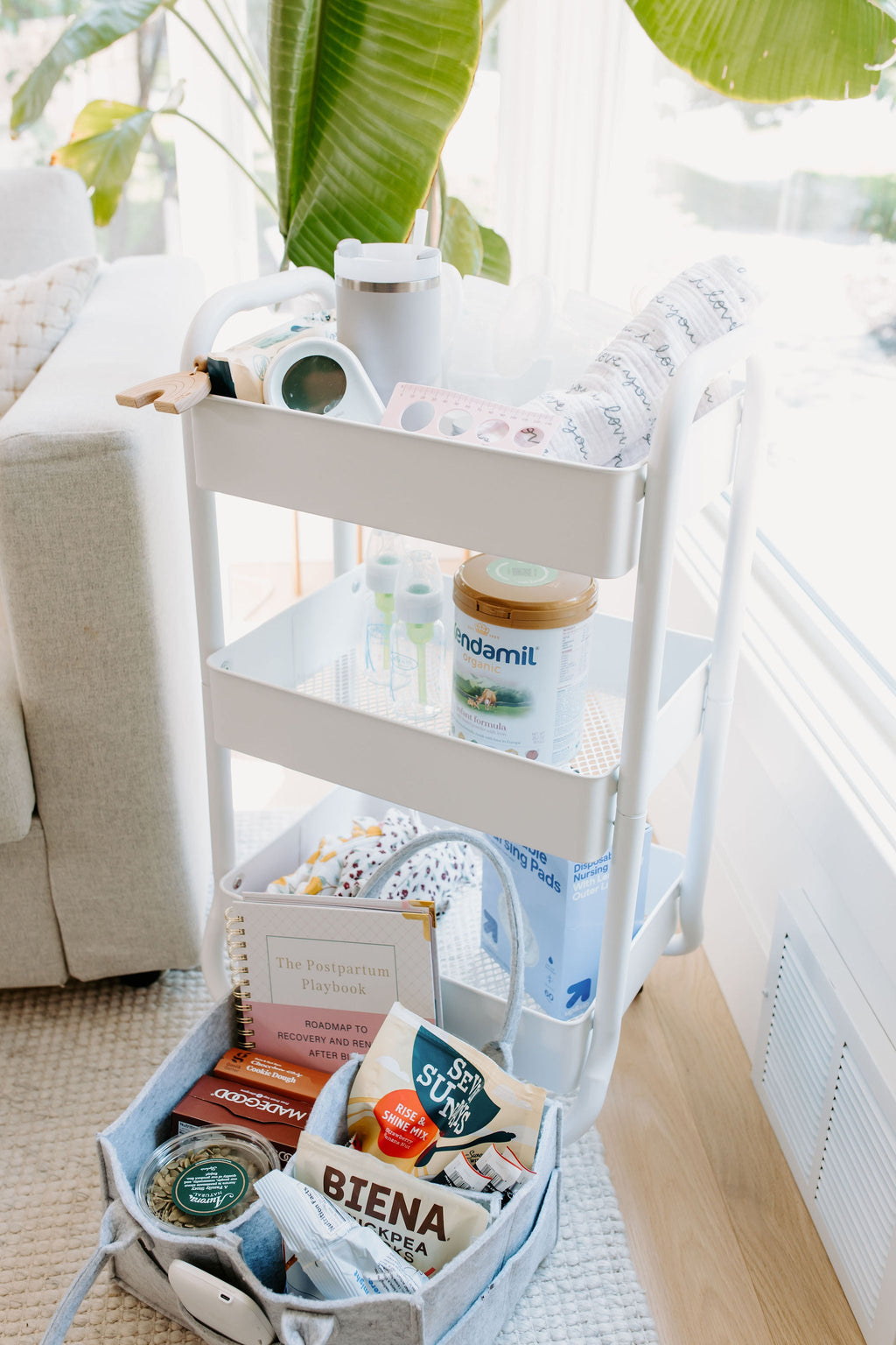Postpartum planner guide book in tote basket on baby supply cart