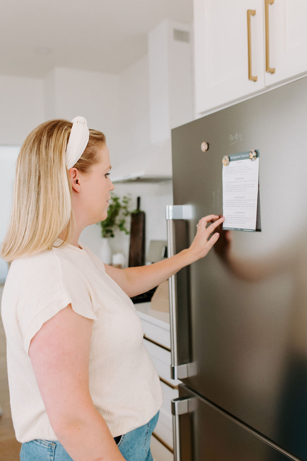 Postpartum planner page placed on a refrigerator door for reference
