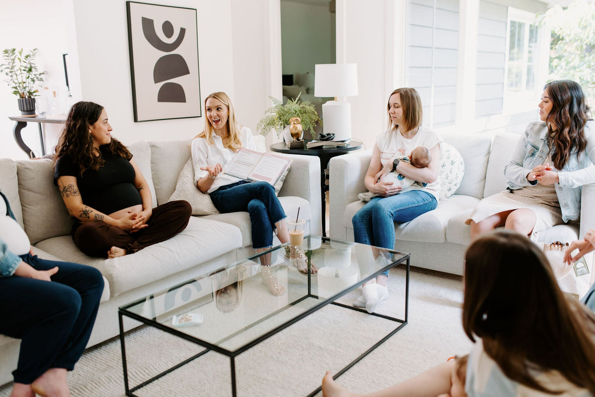 Postpartum planner book open during a small group session on a living room couch