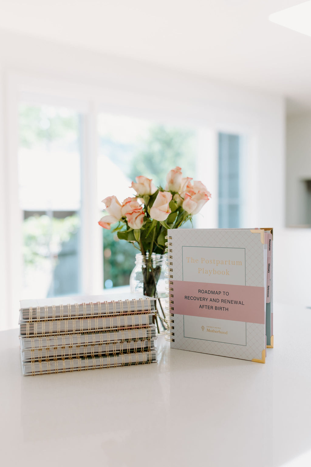 Postpartum planner book with spiral spine on tabletop