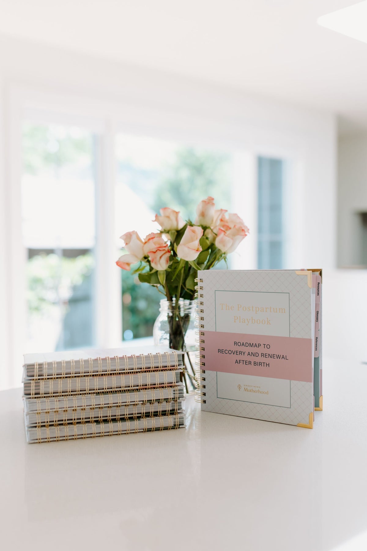 Postpartum planner book with spiral spine on tabletop