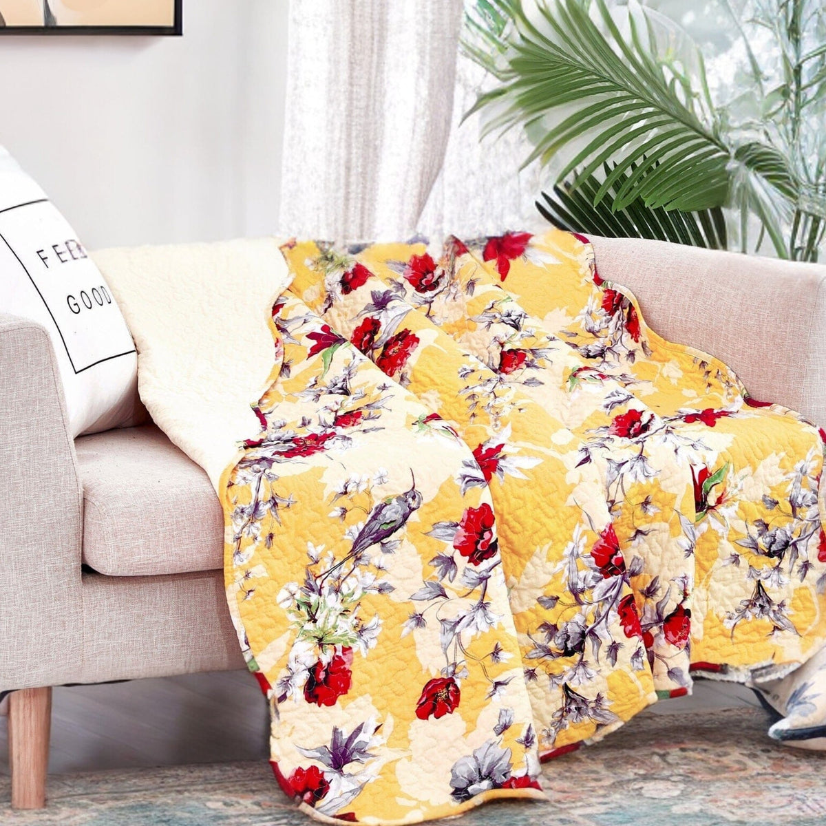 Yellow floral quilted throw blanket with scalloped edges and hummingbird print