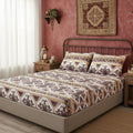 Fitted sheet and pillowcases with ornate kilim-inspired pattern in burgundy, cream, gold